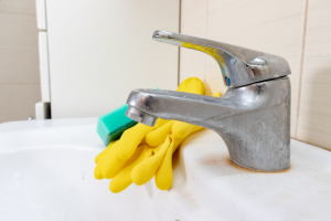 White limescale buildup on a bathroom sink faucet in Barrington, Illinois